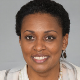 Joyful black young-adult female with short  brown hair and brown eyes