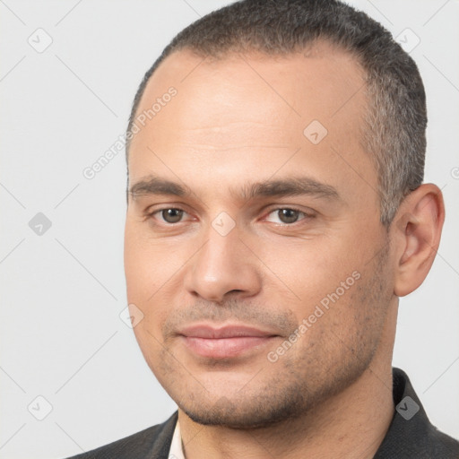 Joyful white young-adult male with short  black hair and brown eyes