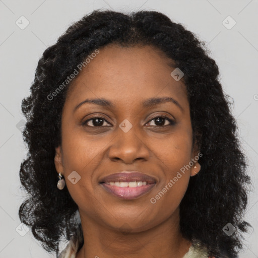 Joyful black young-adult female with long  brown hair and brown eyes