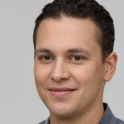 Joyful white adult male with short  brown hair and brown eyes