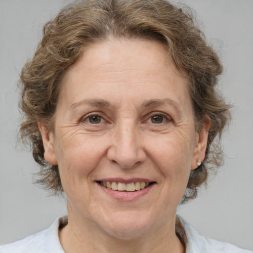 Joyful white middle-aged female with medium  brown hair and brown eyes