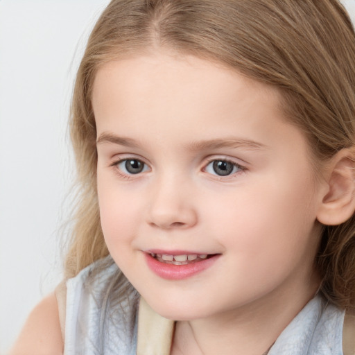 Joyful white child female with medium  brown hair and blue eyes