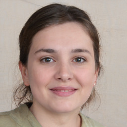 Joyful white young-adult female with medium  brown hair and grey eyes