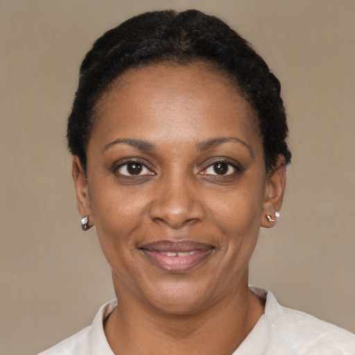 Joyful black adult female with short  black hair and brown eyes