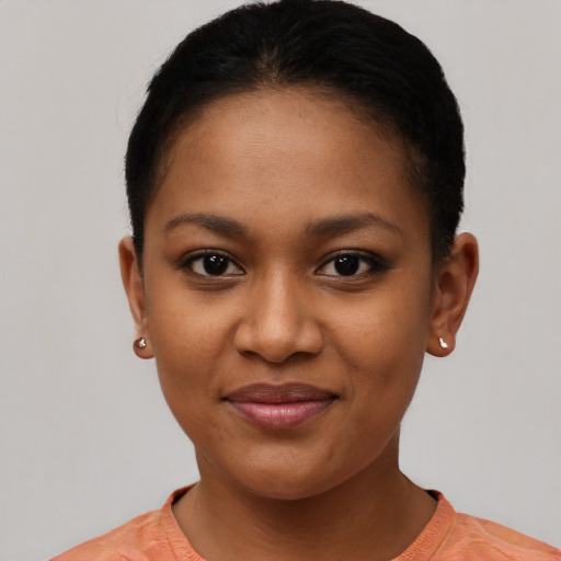 Joyful black young-adult female with short  brown hair and brown eyes