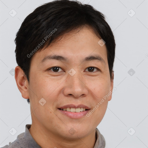 Joyful asian young-adult male with short  brown hair and brown eyes