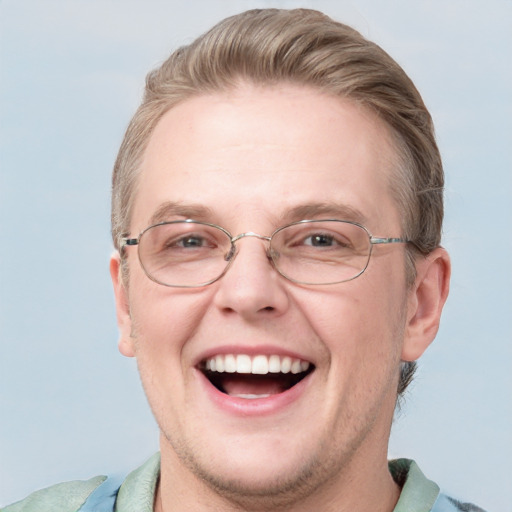 Joyful white adult male with short  brown hair and blue eyes