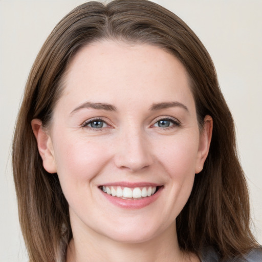 Joyful white young-adult female with long  brown hair and grey eyes