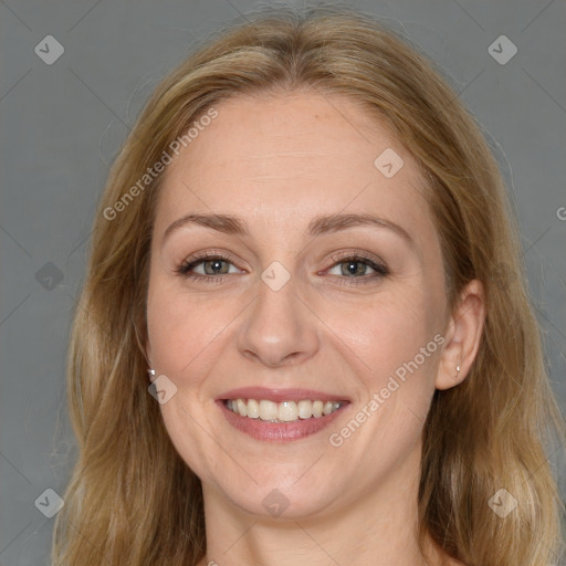 Joyful white adult female with long  brown hair and brown eyes