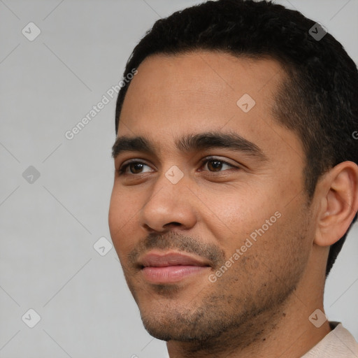 Joyful white young-adult male with short  black hair and brown eyes