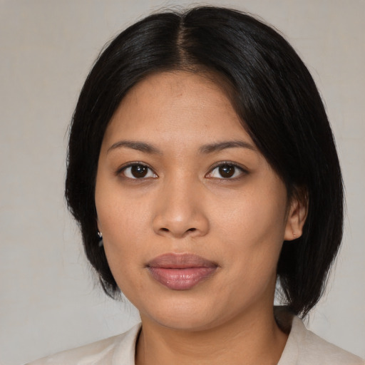 Joyful asian young-adult female with medium  black hair and brown eyes