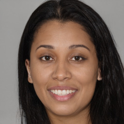 Joyful latino young-adult female with long  brown hair and brown eyes