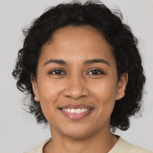 Joyful latino young-adult female with medium  brown hair and brown eyes