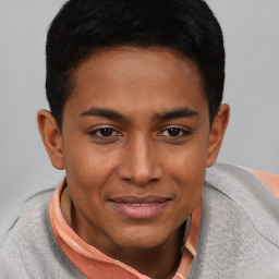 Joyful black young-adult male with short  brown hair and brown eyes