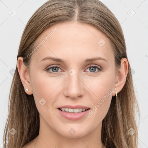 Joyful white young-adult female with long  brown hair and blue eyes