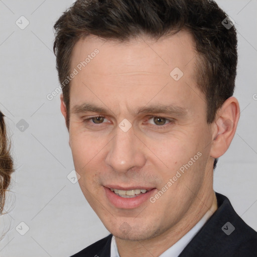 Joyful white adult male with short  brown hair and brown eyes