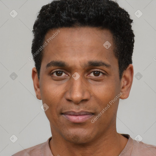 Joyful black young-adult male with short  black hair and brown eyes