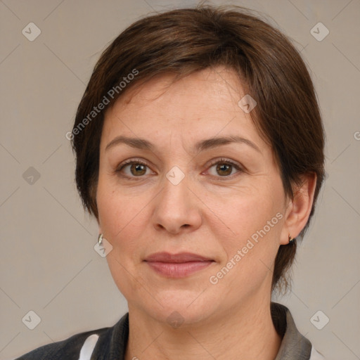 Joyful white adult female with medium  brown hair and grey eyes