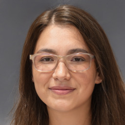 Joyful white adult female with long  brown hair and grey eyes