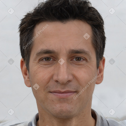 Joyful white adult male with short  brown hair and brown eyes