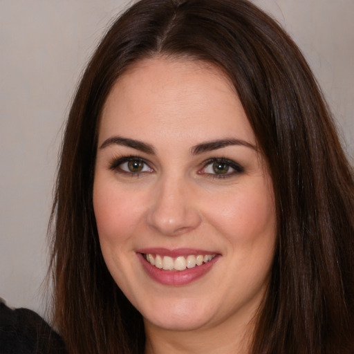 Joyful white young-adult female with long  brown hair and brown eyes