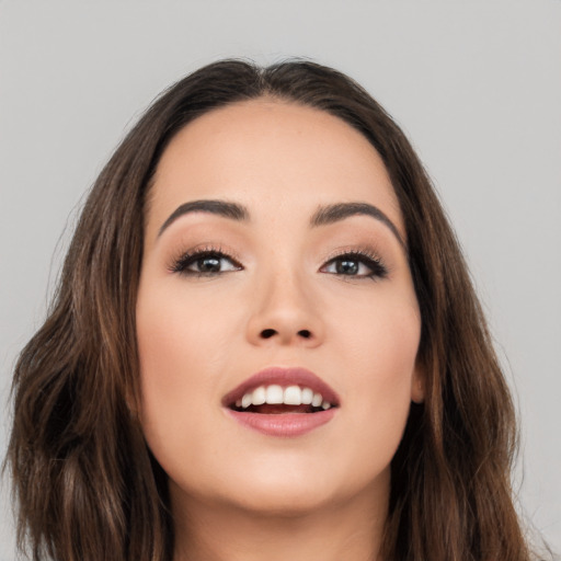 Joyful white young-adult female with long  brown hair and brown eyes