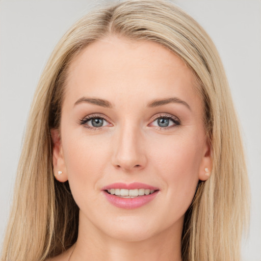 Joyful white young-adult female with long  brown hair and blue eyes