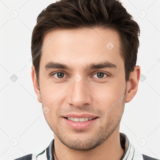 Joyful white young-adult male with short  brown hair and brown eyes