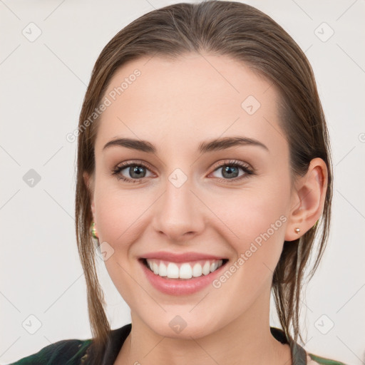 Joyful white young-adult female with long  brown hair and grey eyes