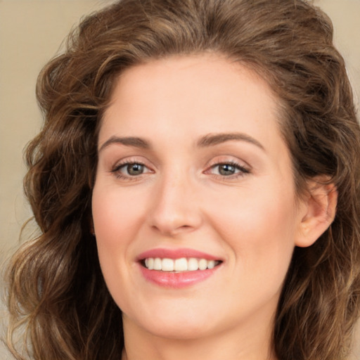 Joyful white young-adult female with long  brown hair and green eyes