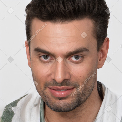 Joyful white young-adult male with short  brown hair and brown eyes