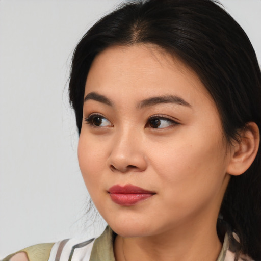 Joyful asian young-adult female with medium  brown hair and brown eyes