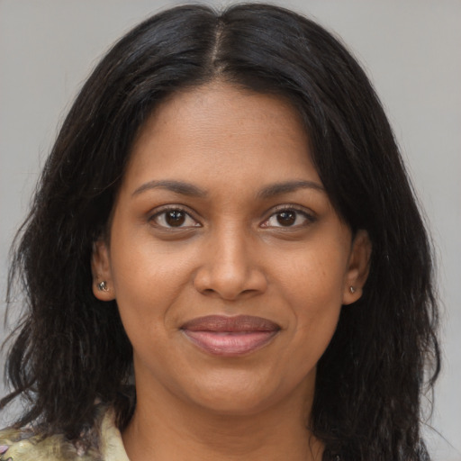 Joyful black young-adult female with medium  brown hair and brown eyes