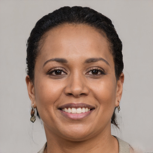 Joyful black adult female with short  brown hair and brown eyes