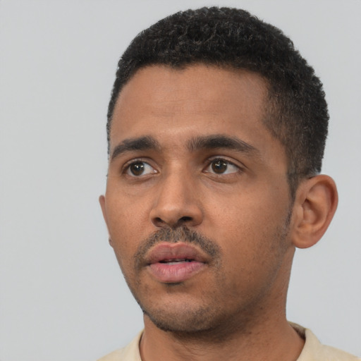 Neutral black young-adult male with short  black hair and brown eyes