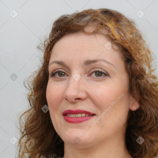 Joyful white adult female with long  brown hair and brown eyes