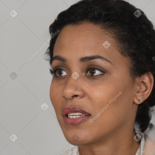 Joyful black young-adult female with short  black hair and brown eyes