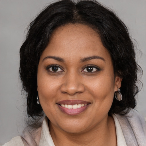 Joyful black young-adult female with medium  brown hair and brown eyes