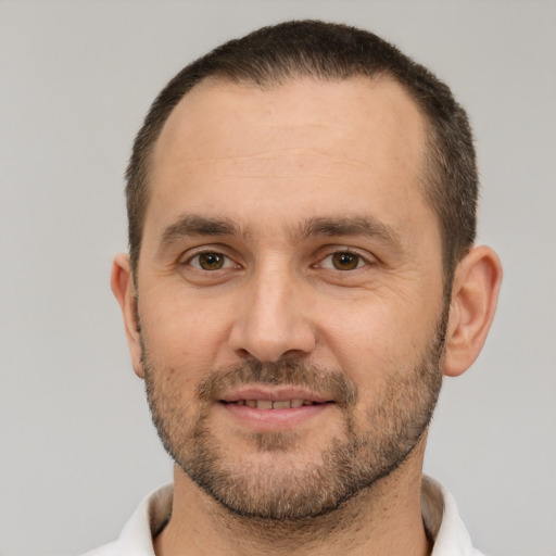 Joyful white adult male with short  brown hair and brown eyes