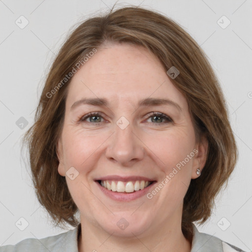 Joyful white adult female with medium  brown hair and grey eyes