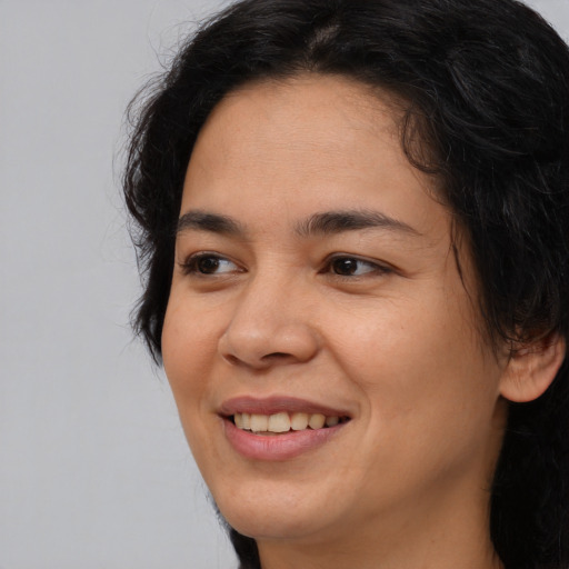 Joyful asian young-adult female with long  brown hair and brown eyes