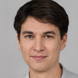 Joyful white adult male with short  brown hair and brown eyes