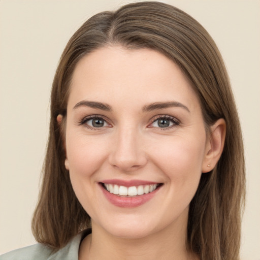 Joyful white young-adult female with long  brown hair and grey eyes