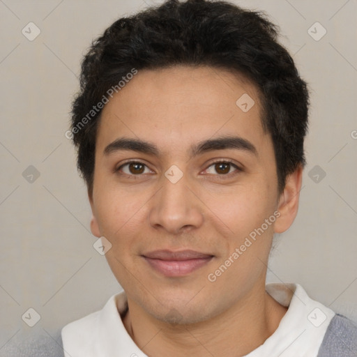 Joyful latino young-adult male with short  brown hair and brown eyes