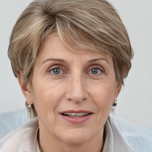 Joyful white adult female with medium  brown hair and blue eyes