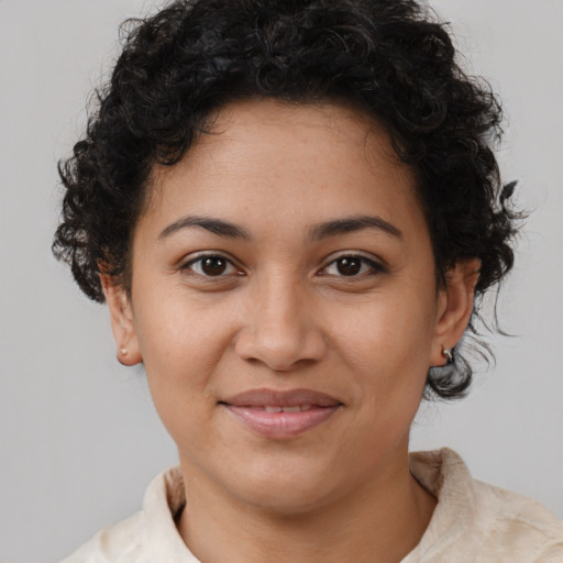 Joyful latino young-adult female with short  brown hair and brown eyes