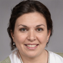 Joyful white adult female with medium  brown hair and brown eyes