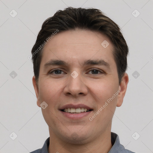 Joyful white young-adult male with short  brown hair and grey eyes