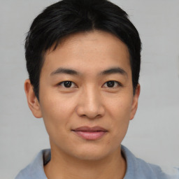 Joyful asian young-adult male with short  brown hair and brown eyes