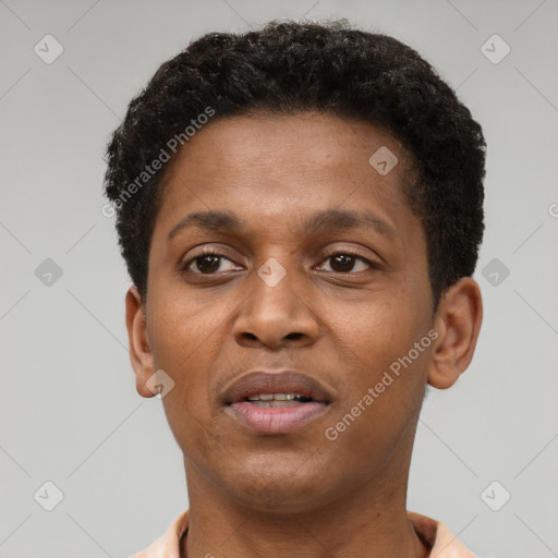 Joyful black young-adult male with short  brown hair and brown eyes